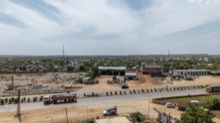 Roadside industrial yard with parked trailers and workshop sheds