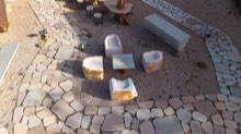 Stone tables and carved pieces arranged on the display floor