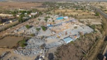 Full site view showing yards, sheds, and stockpiles