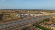 Highway approach with farmland and service station in view