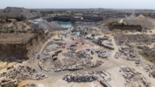 Terraced quarry opening with cut stone laid out below