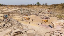 Active extraction floor with loaders, workers, and cut slabs