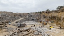 Working floor with trucks, slab stock, and quarry walls