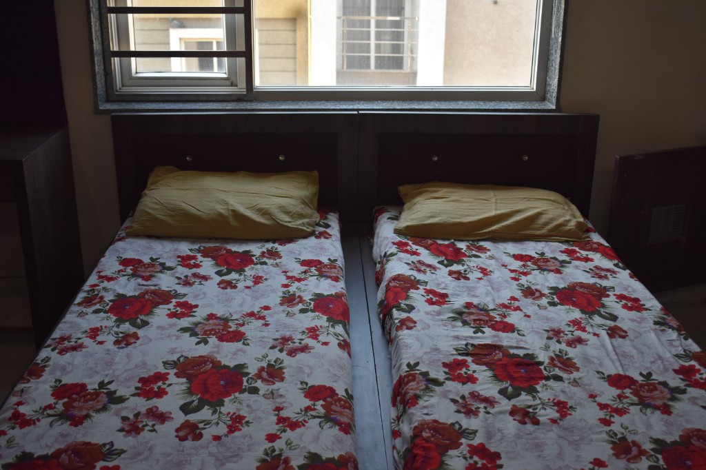 Two beds with headboard and window